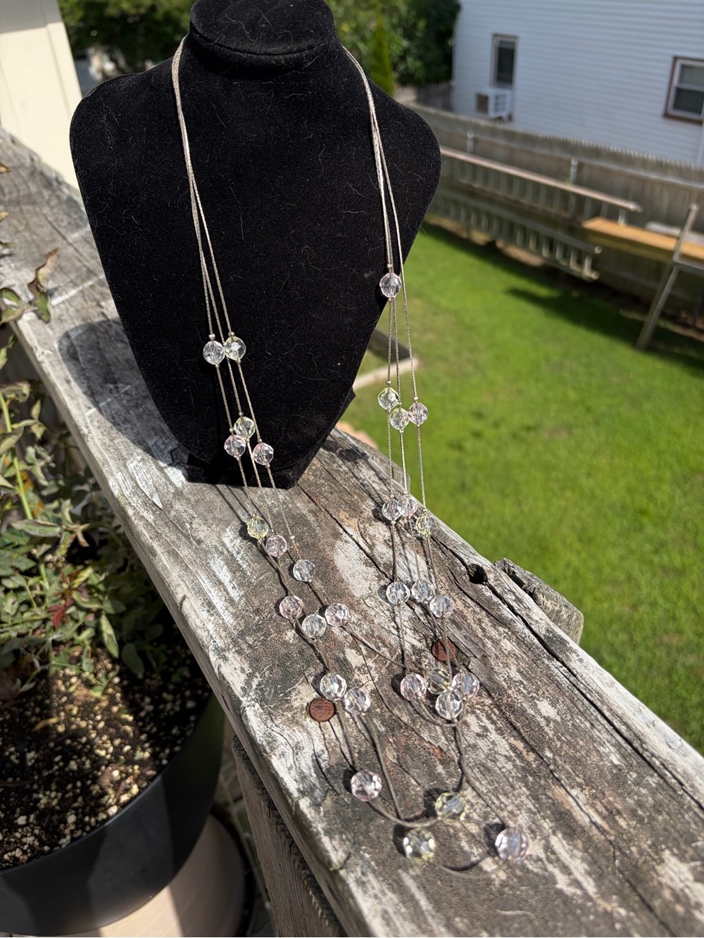 Lady Remington floating necklace features beads strung on a silvertone wire